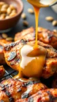 sweet and tangy mustard sauce pours on a piece of roasted chicken on a grill